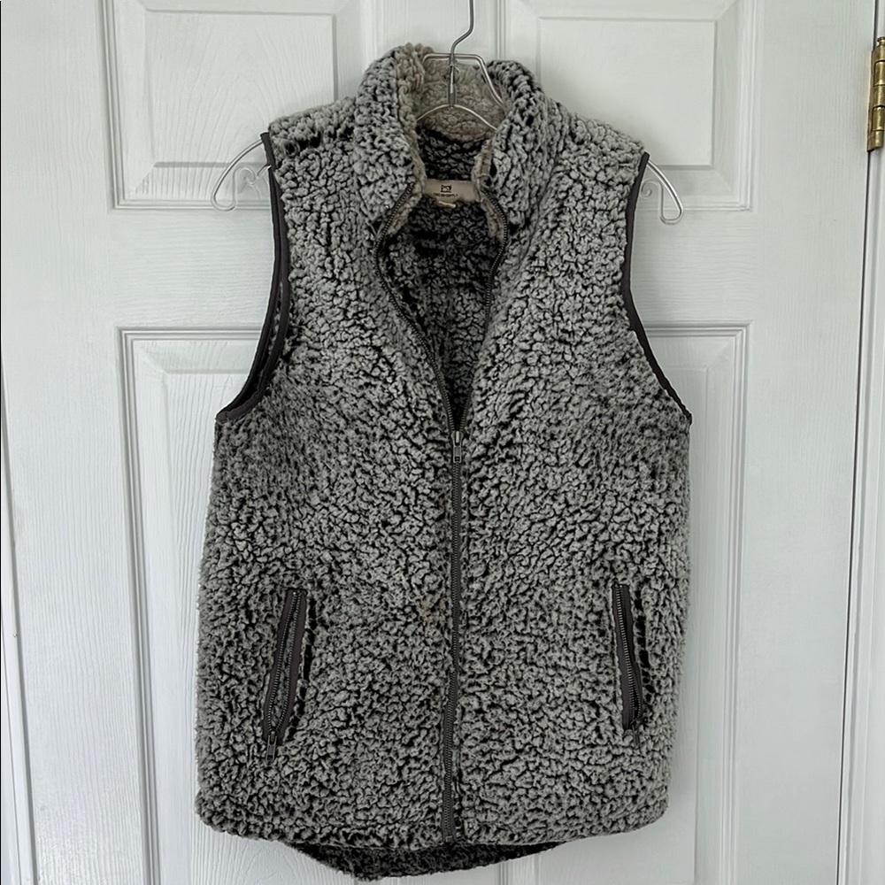 Cozy gray Sherpa vest with zippered front pockets.
